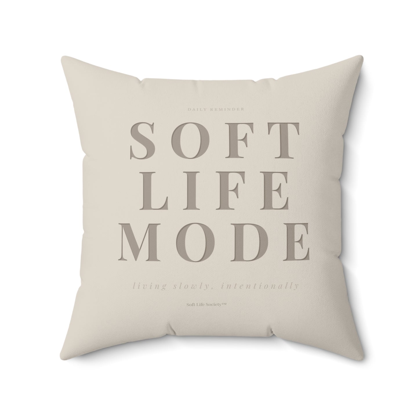 Beige pillow with 'SOFT LIFE MODE' text on a white background