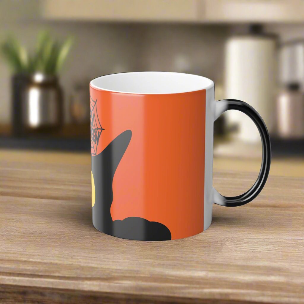 Magic morphing Halloween mug with black cat design on an orange background, 11oz coffee cup