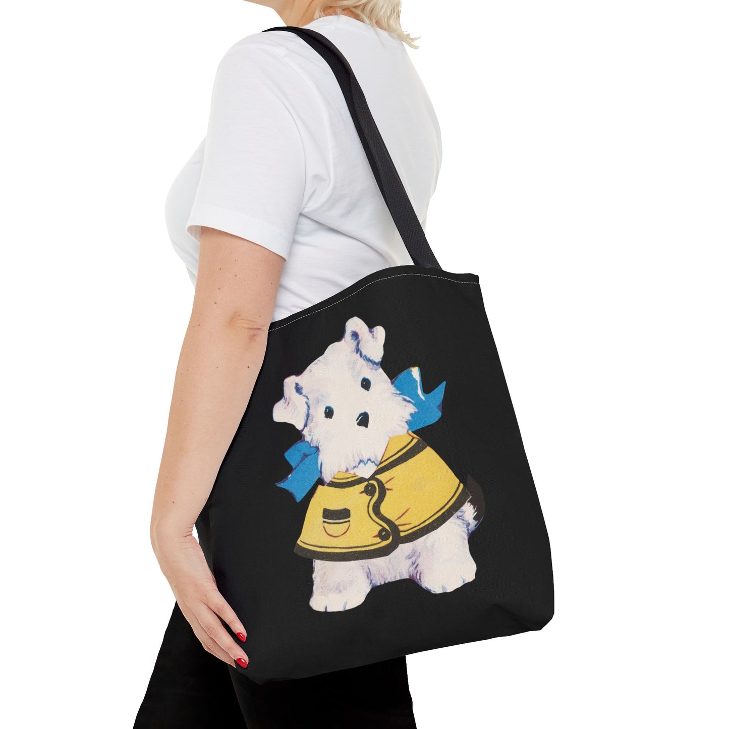 Close-up of the Bitsy puppy illustration on the tote bag, highlighting the intricate details of the yellow jacket and blue bow.