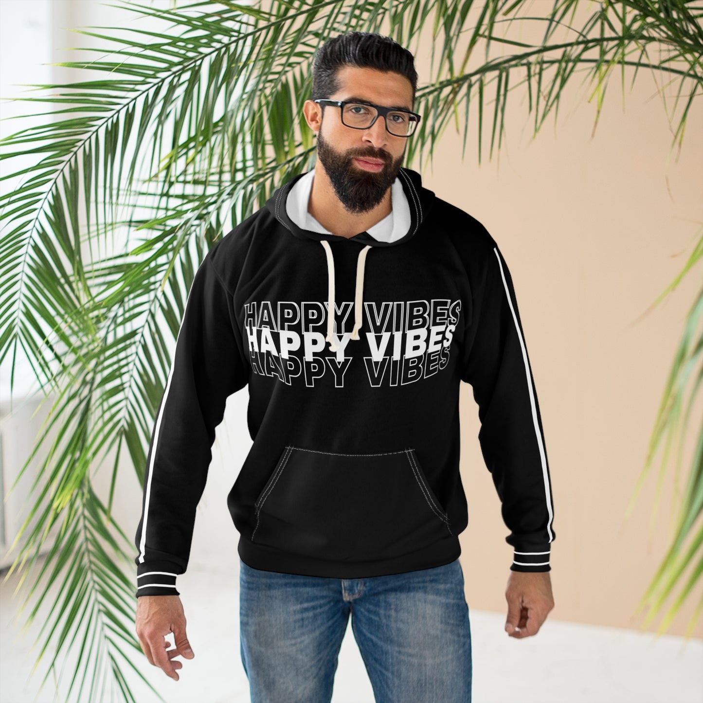 Person wearing black Happy Vibes hoodie front design with bold typography