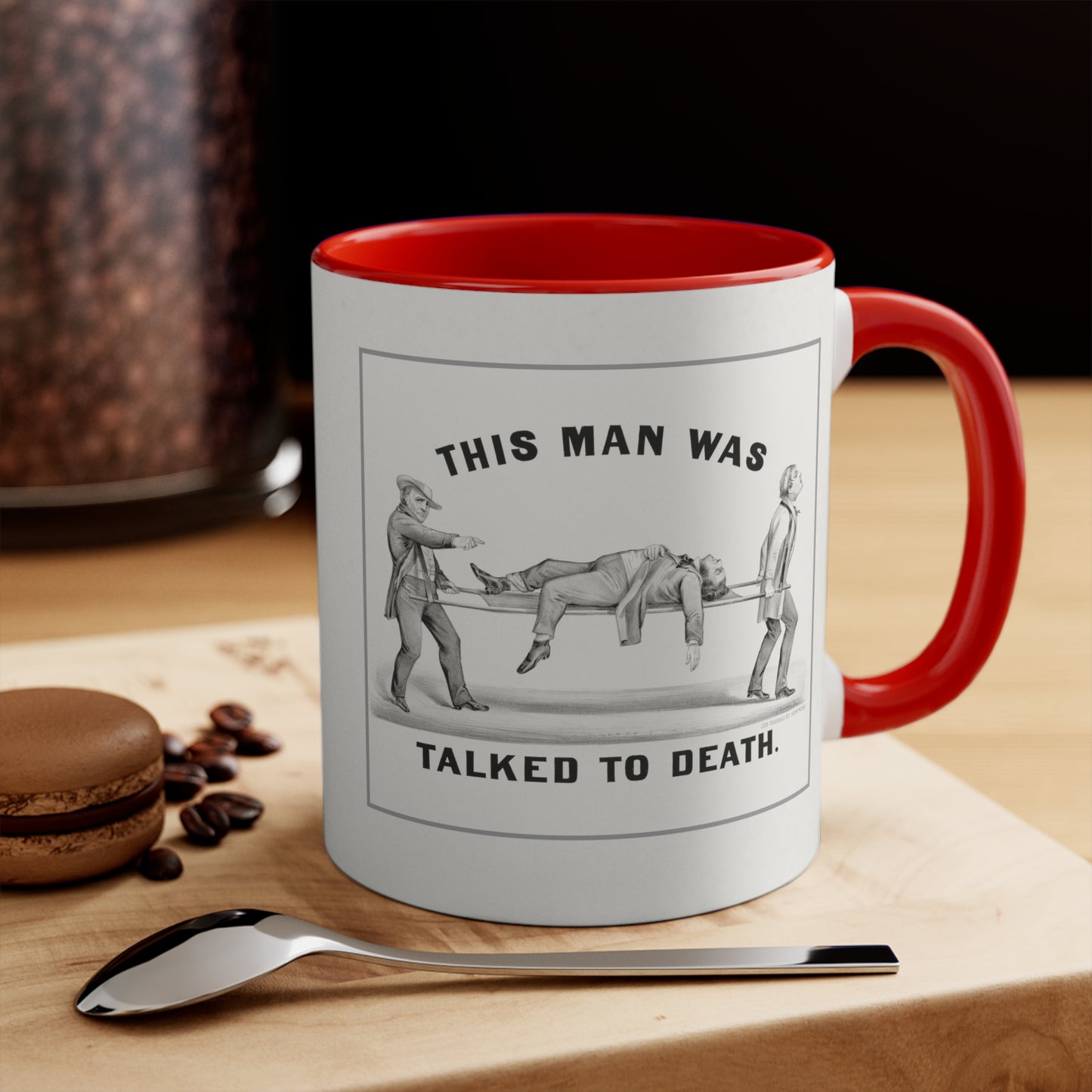 "Talked to Death" vintage humor mug with red handle and interior, placed on a table