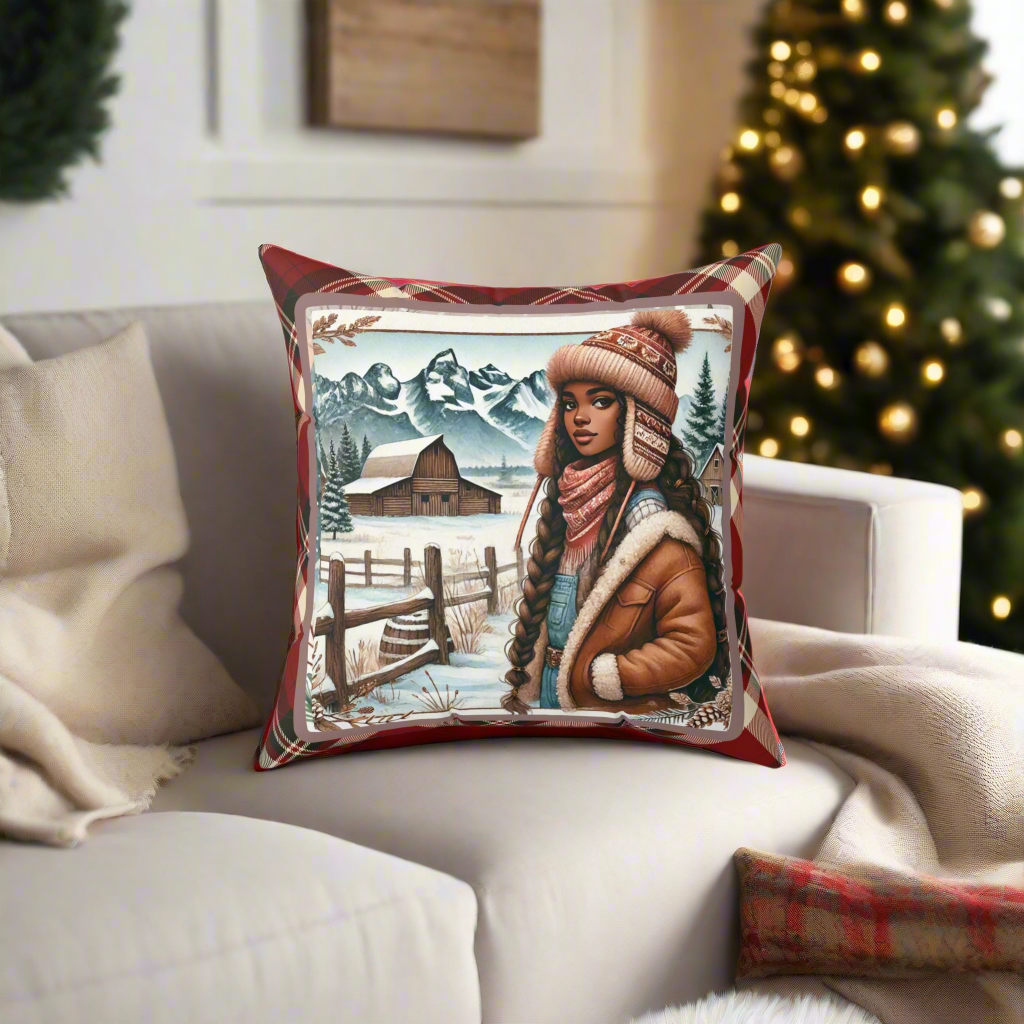A cozy living room setting featuring a decorative throw pillow with a winter-themed design of a stylish woman in a warm jacket and knit hat, standing on a snowy ranch backdrop with rustic barns and snow-capped mountains. The pillow is set against a beige sofa with festive holiday decor, including a Christmas tree adorned with golden lights in the background.