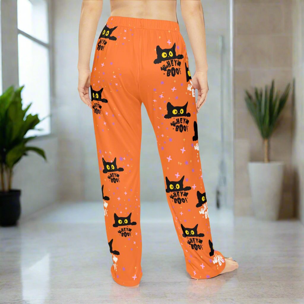 Hey Boo black cat women's Halloween pajama pants with orange background, comfortable sleepwear