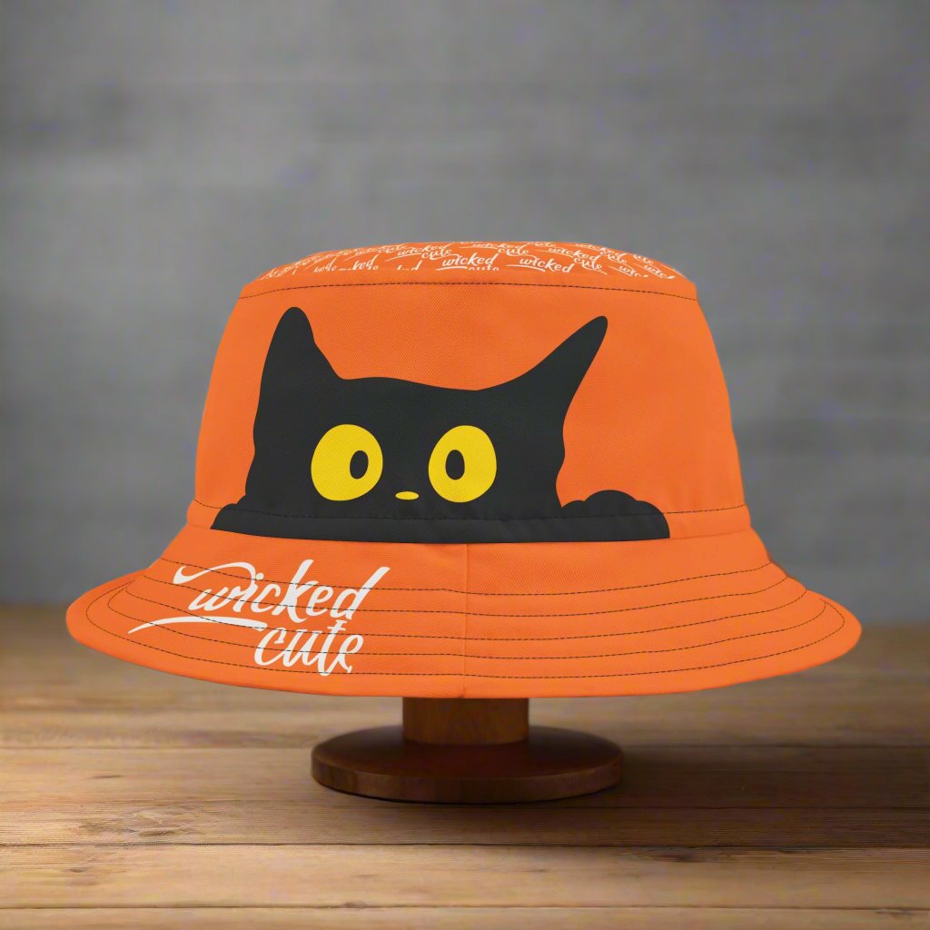 Front view of the Wicked Cute Black Cat Halloween Bucket Hat showcasing a playful black cat design on an orange background.