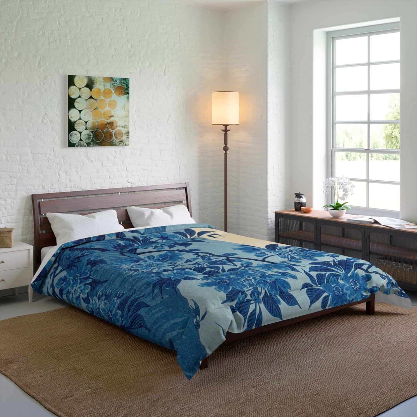 Blanket styled on a king-sized bed with matching décor in a modern, well-lit bedroom.