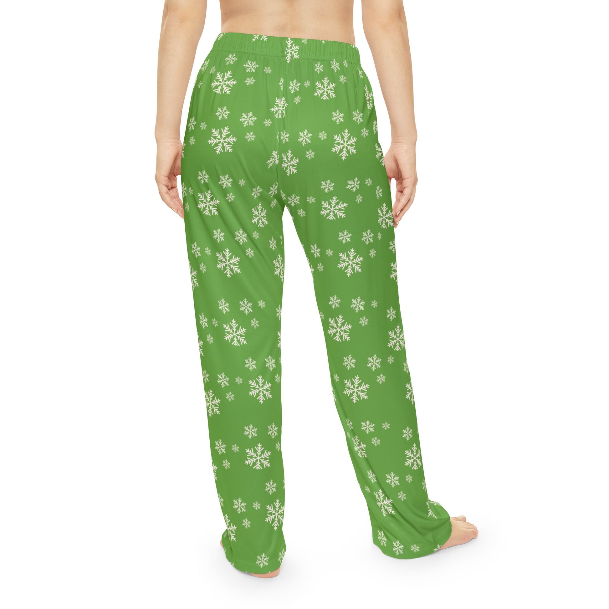 Woman wearing cozy Christmas pajama bottoms, showing snowflake pattern and relaxed fit.