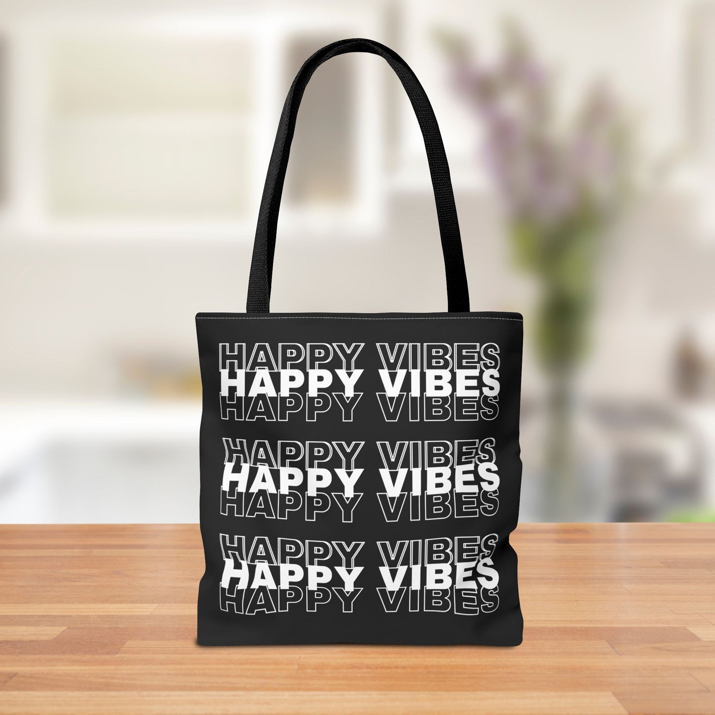 Reversible tote bag featuring bold "Happy Vibes" text repeated in white.