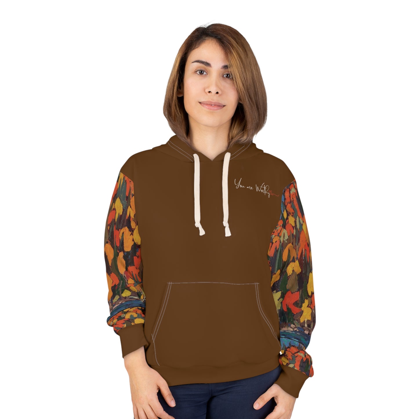Woman modeling the autumn foliage hoodie, showing the front “You are Worthy” design and vibrant fall leaves on sleeves.