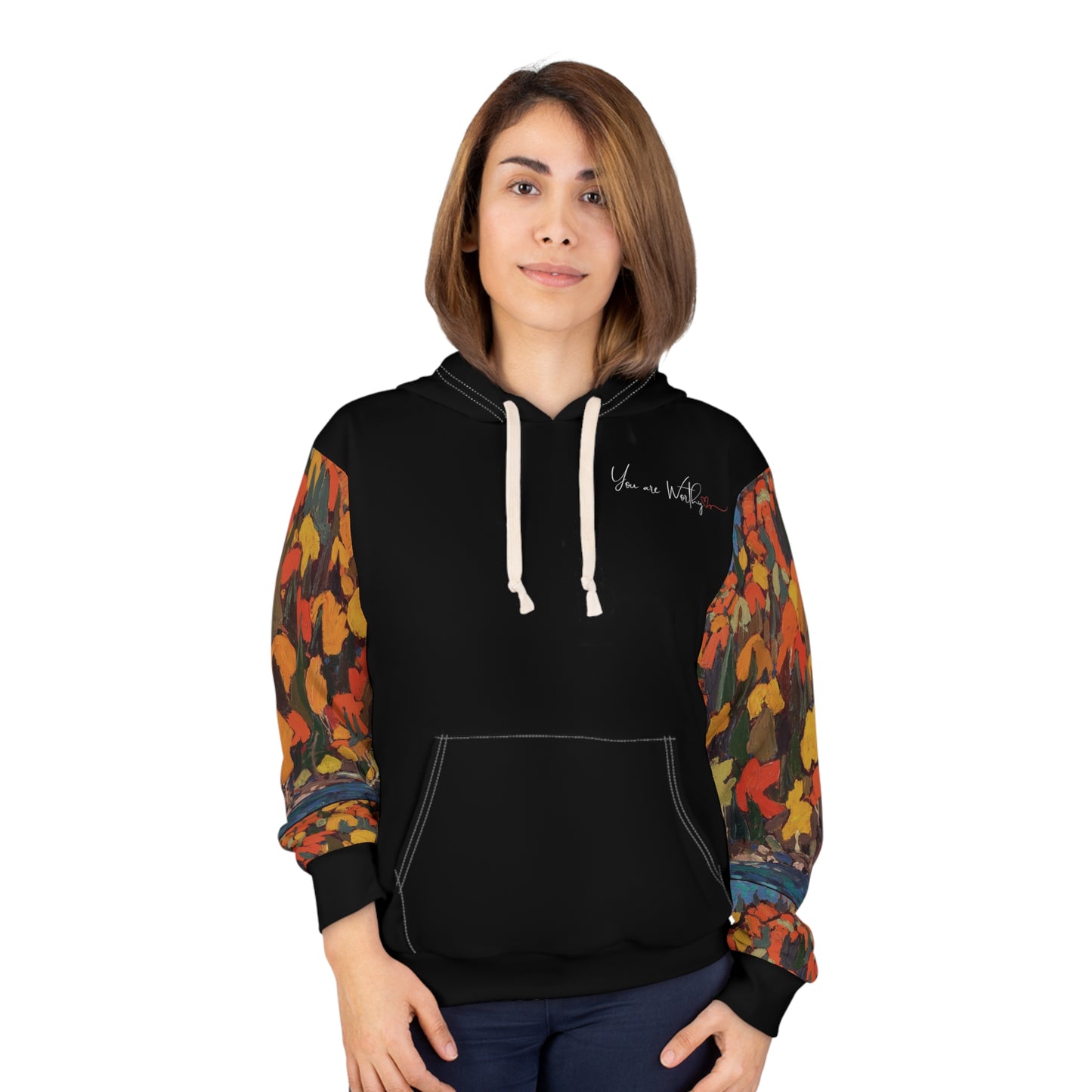 Woman modeling the autumn foliage hoodie, showing the front “You are Worthy” design and vibrant fall leaves on sleeves.