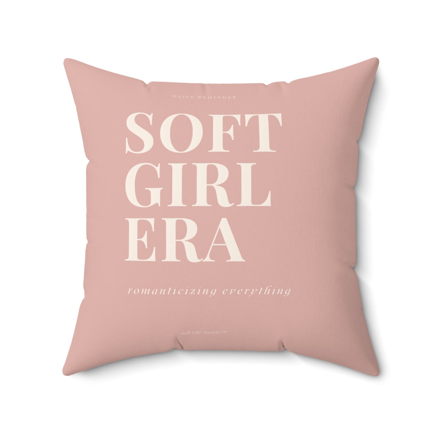 Pink pillow with 'SOFT GIRL ERA' text on a white background