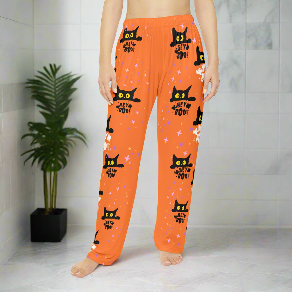 Hey Boo black cat women's Halloween pajama pants with orange background, comfortable sleepwear
