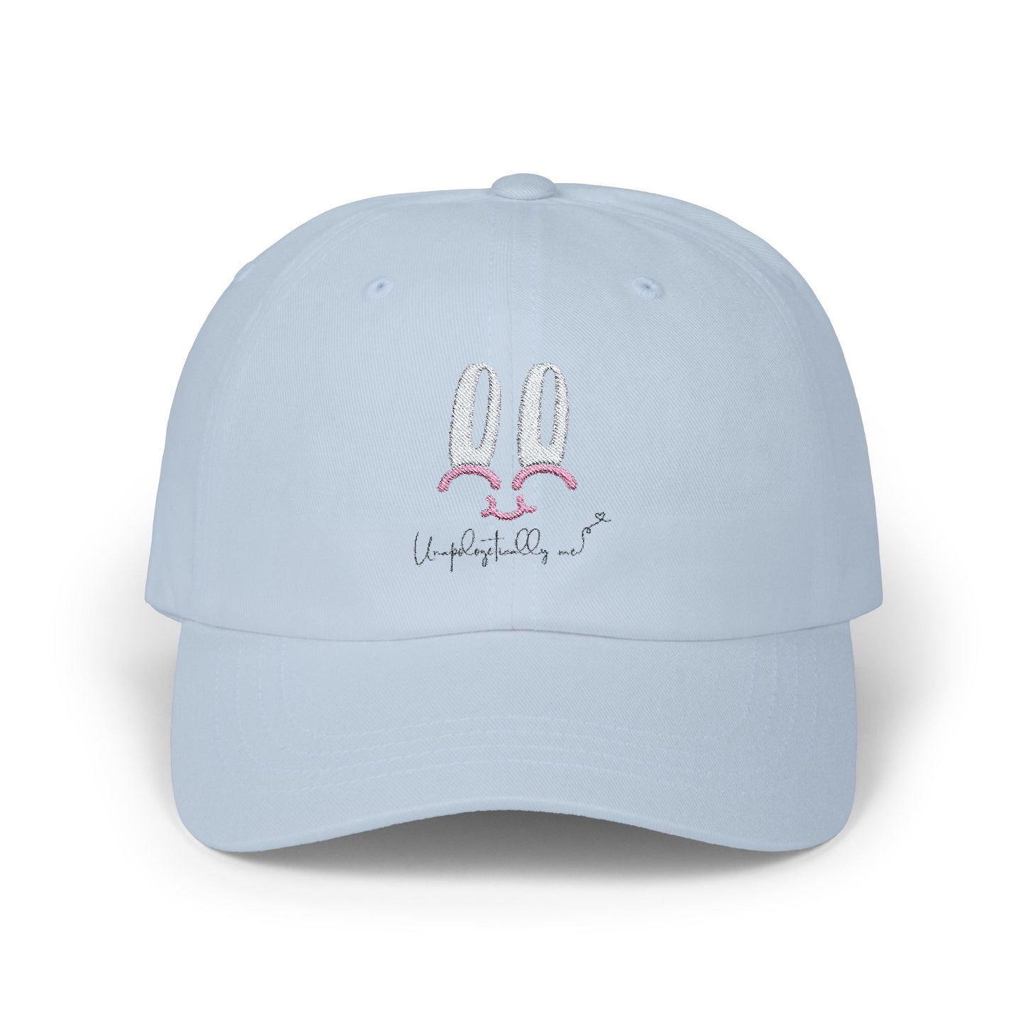 Front view of the Unapologetically Me Classic Dad Hat in sky blue color with pink bunny logo