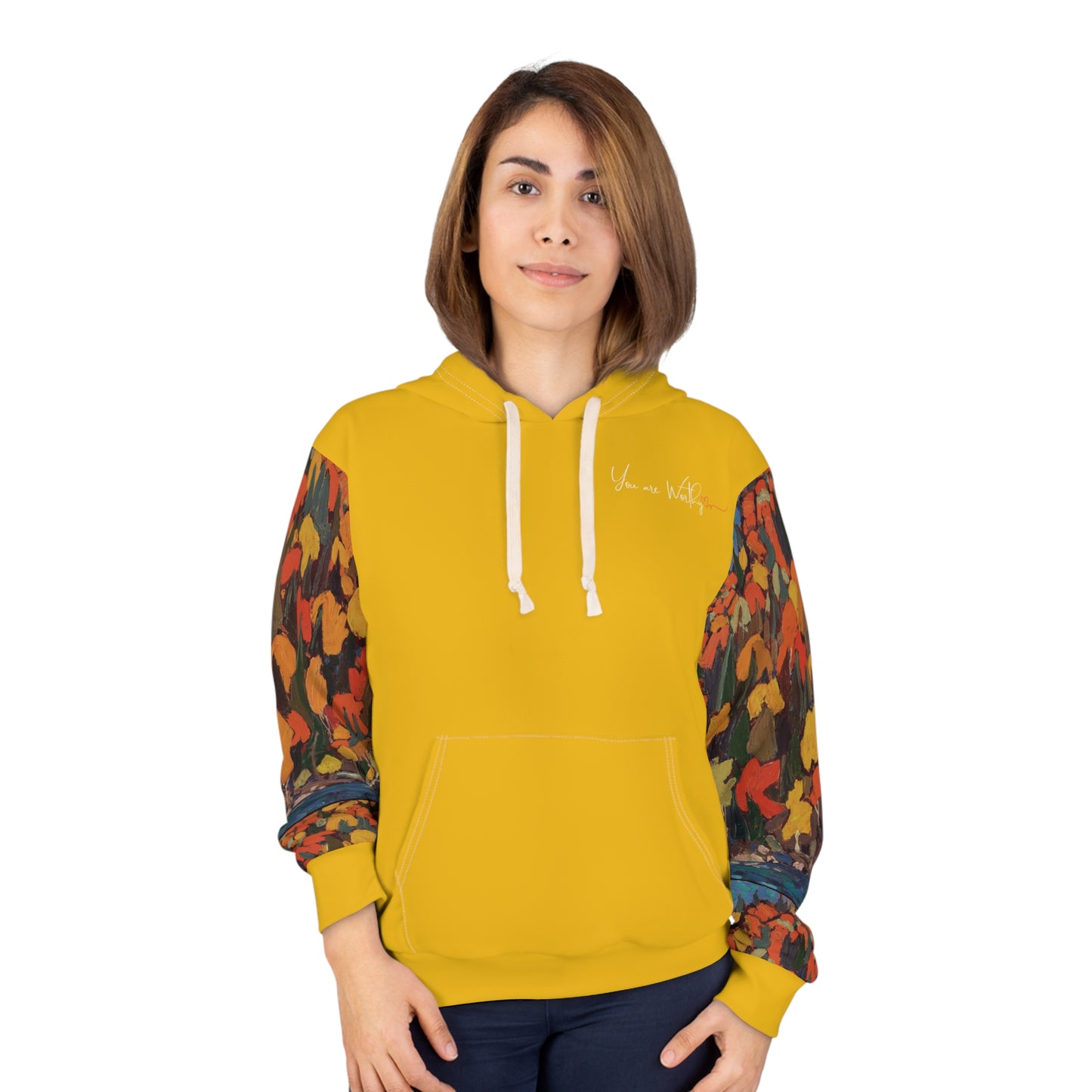 Woman modeling the autumn foliage hoodie, showing the front “You are Worthy” design and vibrant fall leaves on sleeves.