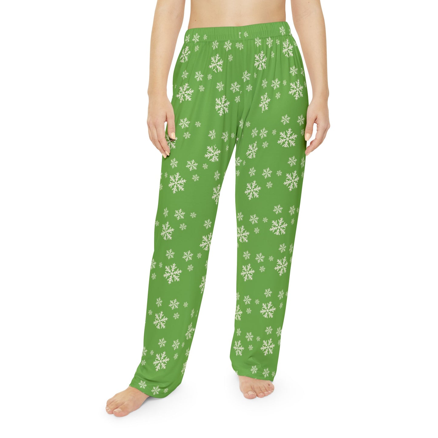 Woman wearing cozy Christmas pajama bottoms, showing snowflake pattern and relaxed fit.