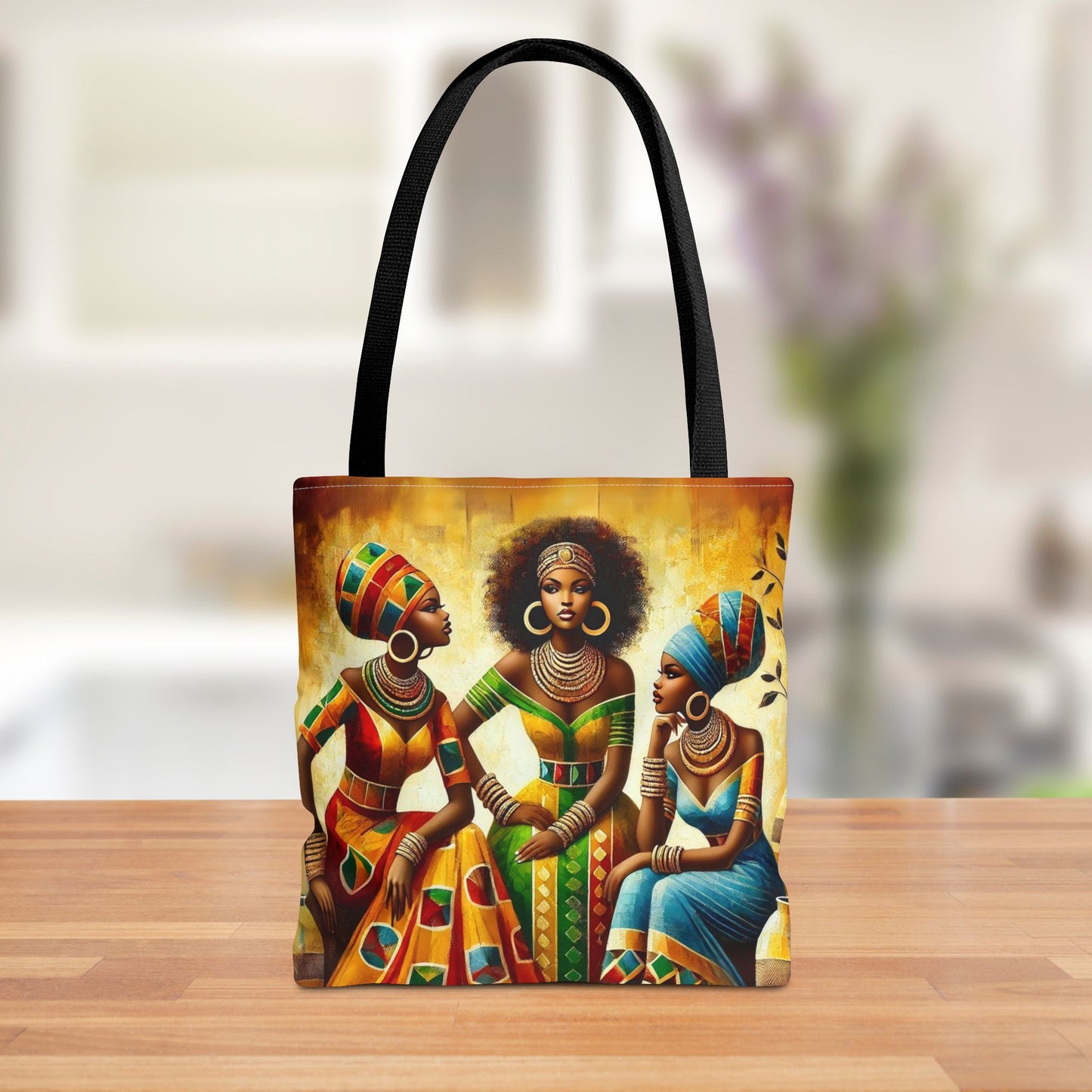 Front view of an African Queens Tote Bag featuring three elegant women in tribal attire with vibrant colors and intricate patterns.