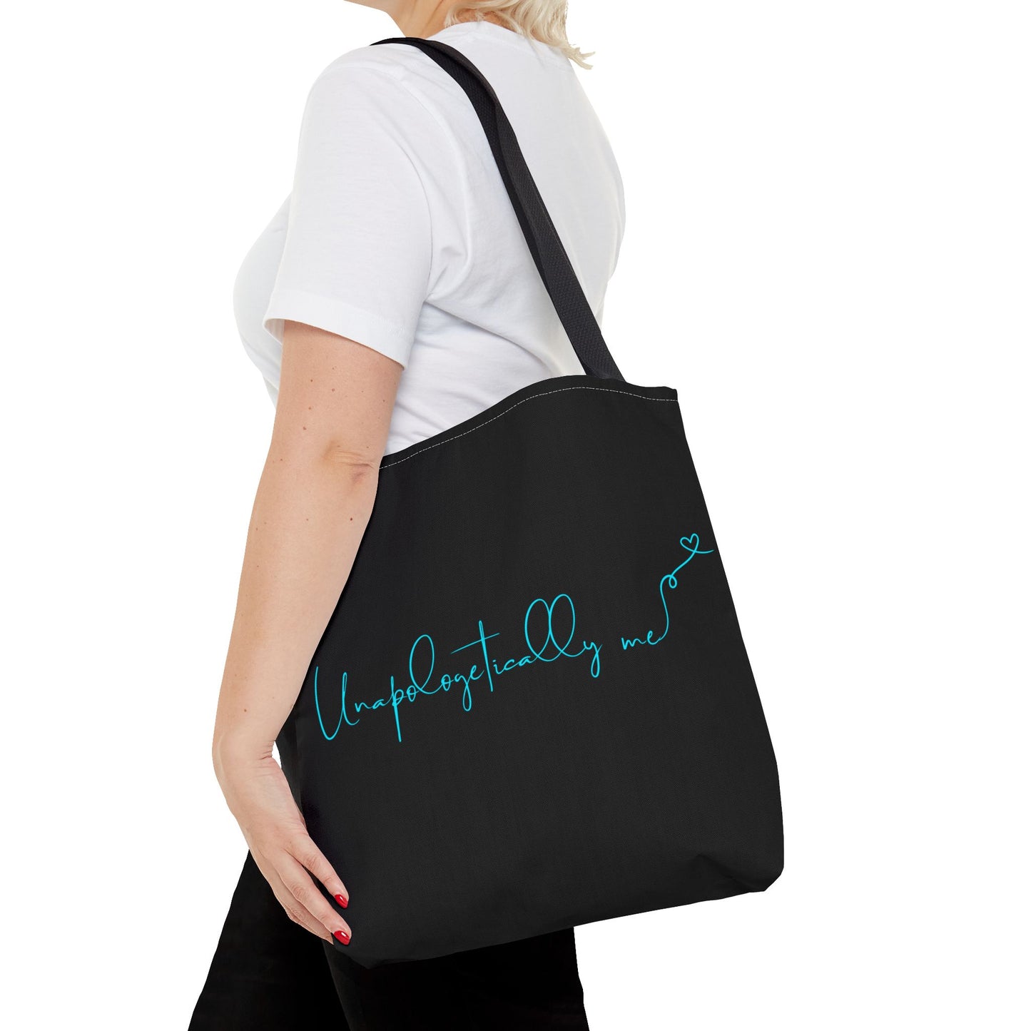 Woman carrying the Unapologetically Me tote bag, showcasing motivational design in teal.