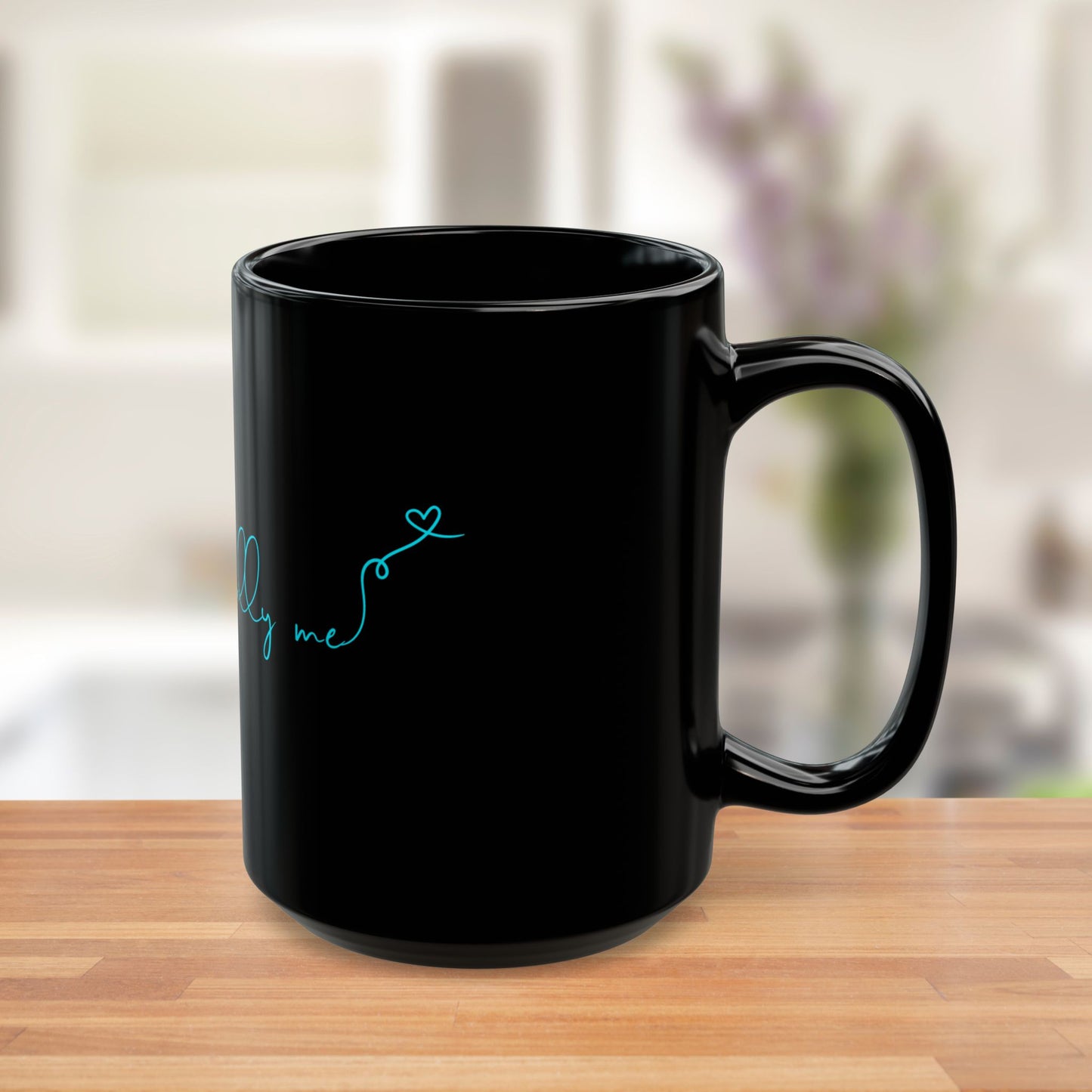 Side view of black ceramic mug with bold teal Unapologetically Me message.