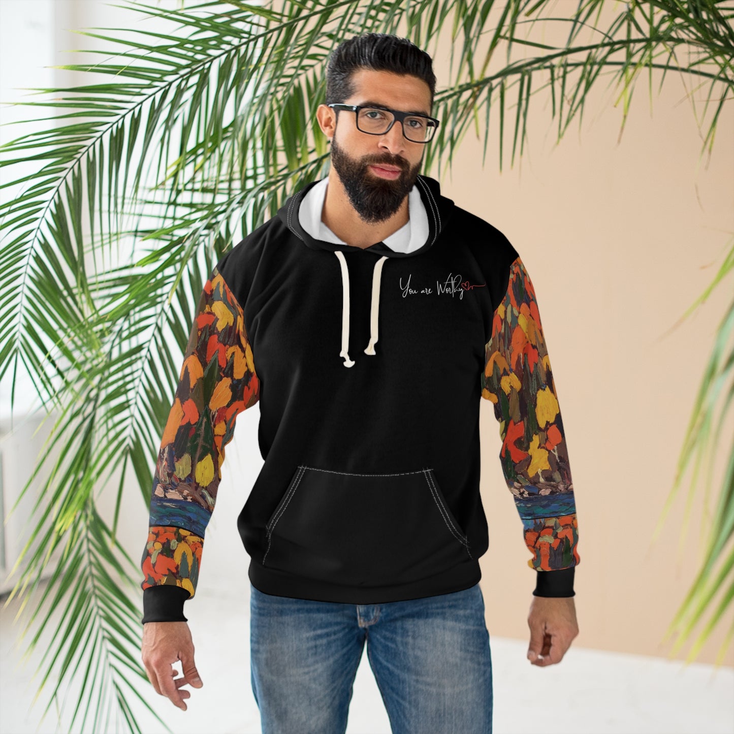Man modeling the autumn foliage hoodie, displaying the motivational back design with inspiring message and art.