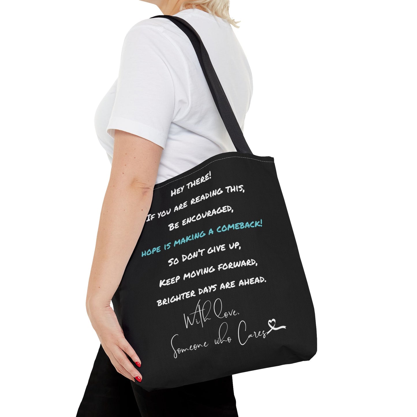 Lifestyle image of a person holding the inspirational tote bag, showcasing its size and stylish design with an empowering message.