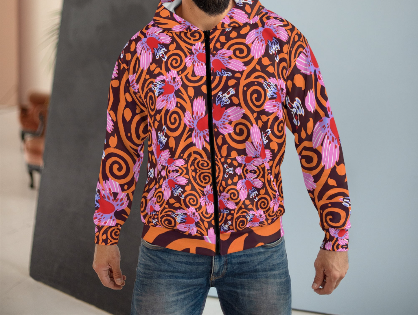 Front view of the E. A. Séguy-inspired hoodie showcasing vibrant Art Deco floral and swirl patterns in shades of orange, pink, and red. The unisex hoodie features a bold design across the entire front