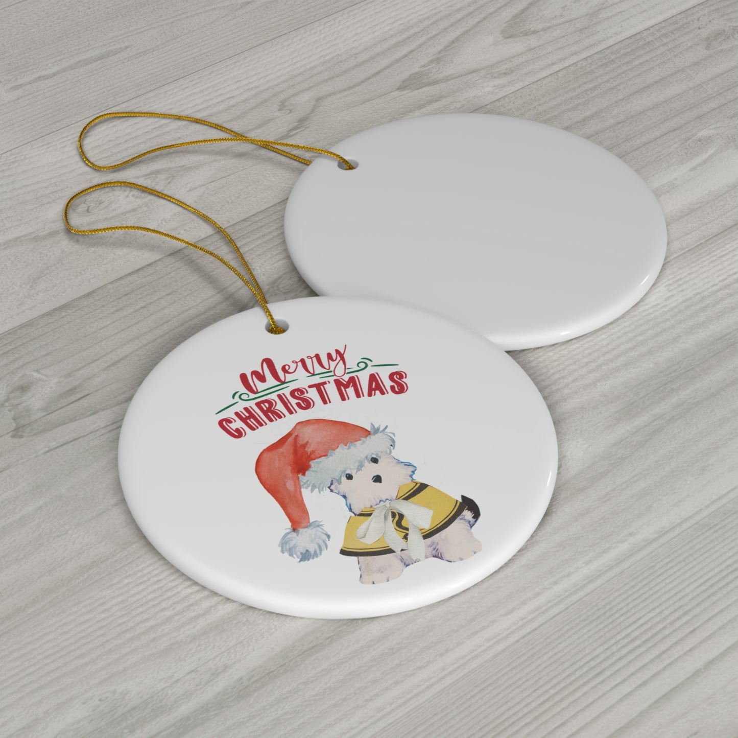 Lifestyle view of a ceramic ornament with a cute puppy in a Santa hat and yellow coat, with the words 'Merry Christmas' in red and green, perfect for holiday tree decoration.