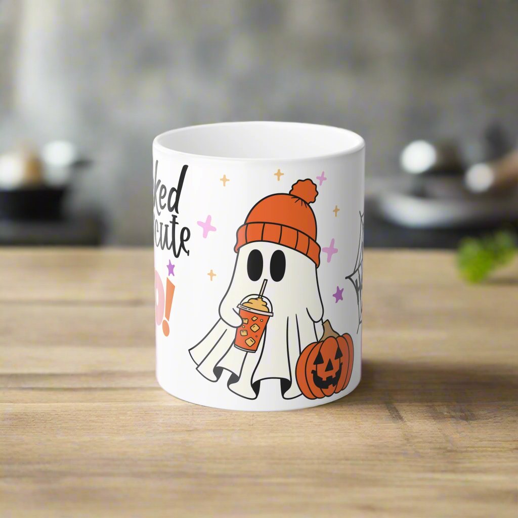 Front view of Wicked Cute Halloween Boo Magic Morphing Mug with a white background, featuring a cute ghost in an orange beanie holding a pumpkin-themed drink, and a pumpkin on the side