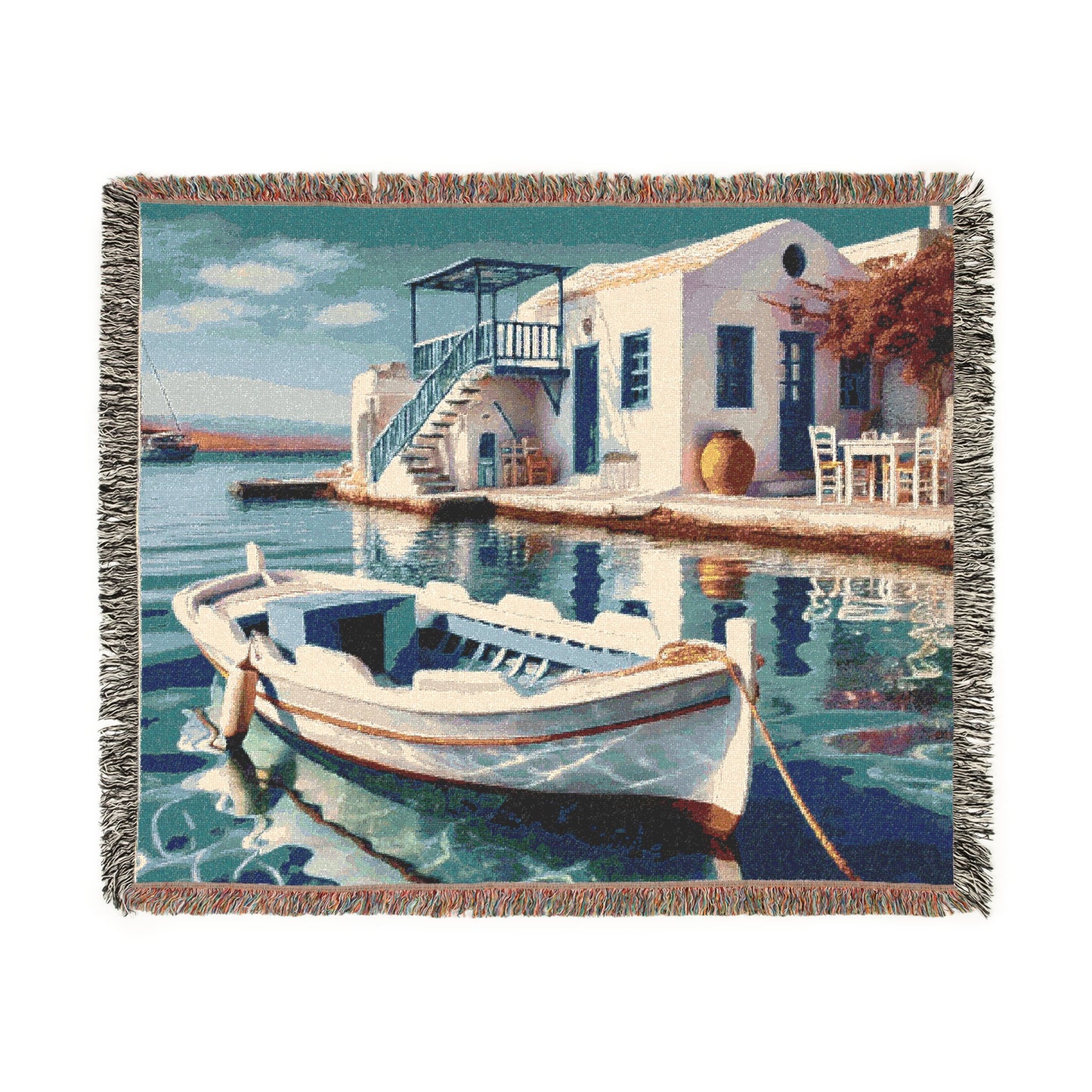 Nautical-themed woven blanket draped over a cozy armchair, showcasing its fringed edges.