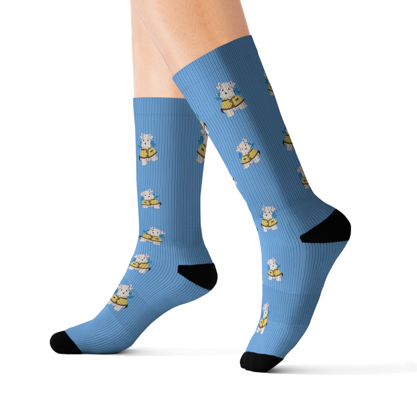 View of light blue crew socks featuring a repeating vintage Bitsy puppy design with a yellow jacket and blue bow.