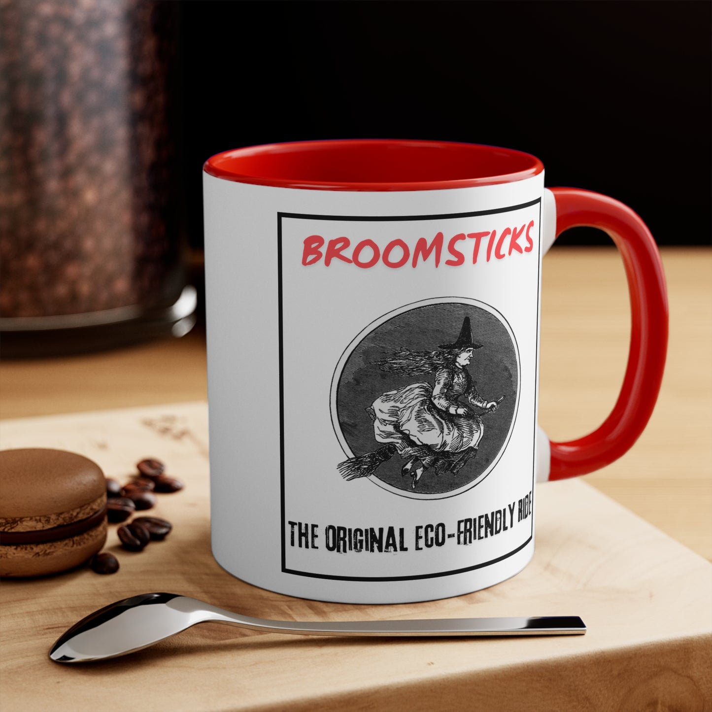 Red Interior: Side view of a white mug with red handle and interior, depicting a whimsical witch design and humorous eco-friendly message.