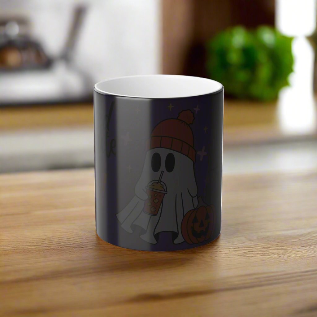 Pre-state view of the Wicked Cute Halloween Boo Magic Morphing Mug. The mug is in its cold state, appearing dark and concealing the vibrant ghost and pumpkin design underneath, as the heat-activated effect has not yet been triggered.