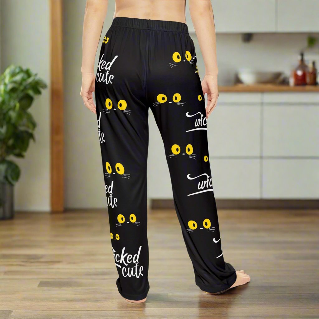Back view of Wicked Cute Black Cat Women's Pajama Pants displaying the same playful yellow cat eyes and Wicked Cute text pattern on a black background