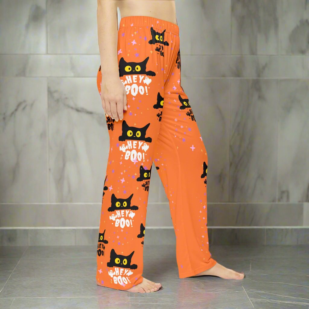 Hey Boo black cat women's Halloween pajama pants with orange background, comfortable sleepwear