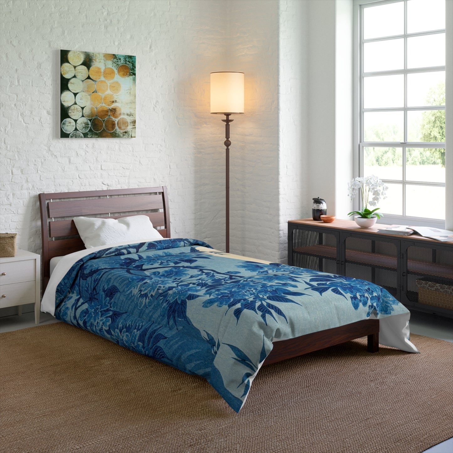 Blanket draped over a twin-sized bed for a cozy look in a minimalist room.