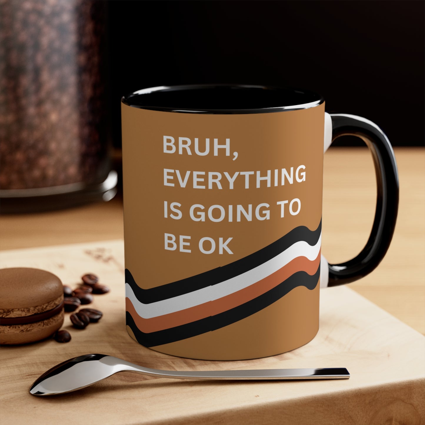 Bruh, Everything is Going to Be OK motivational coffee mug with black interior, shown on a wooden table with a spoon and coffee beans