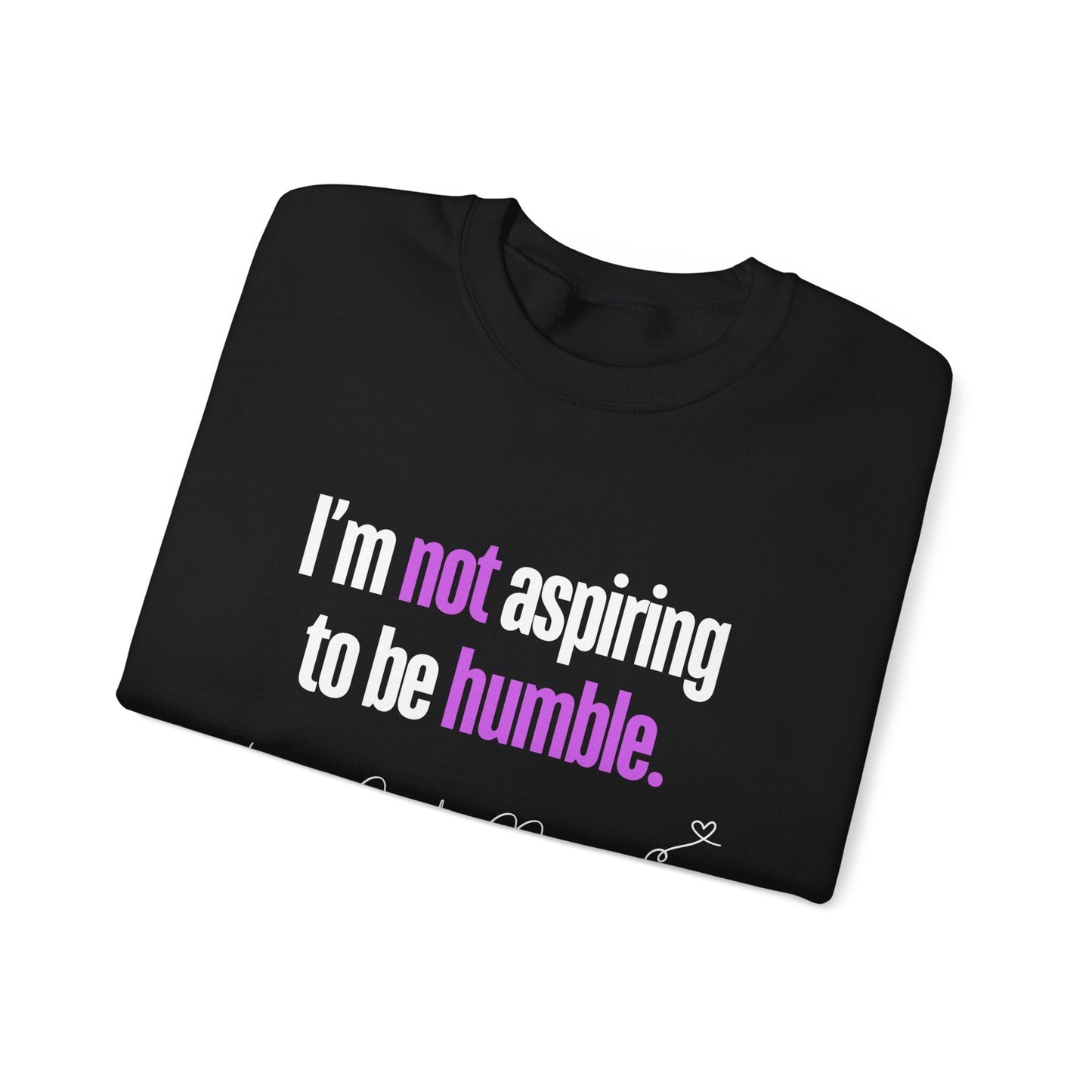 Folded view of sweatshirt featuring the quote "I'm Not Aspiring To Be Humble" in bold white and purple text, with "Unapologetically Me" script at the bottom.