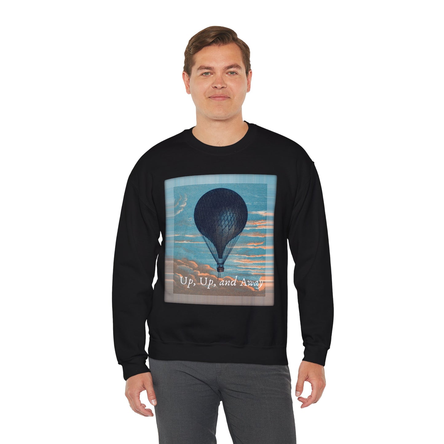 Lifestyle image of a man wearing the "Up, Up, and Away" sweatshirt in black, standing outdoors