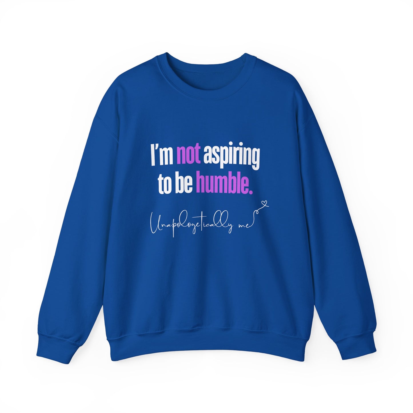A royal blue sweatshirt featuring the quote "I'm Not Aspiring To Be Humble" in bold white and purple text, with "Unapologetically Me" script at the bottom.