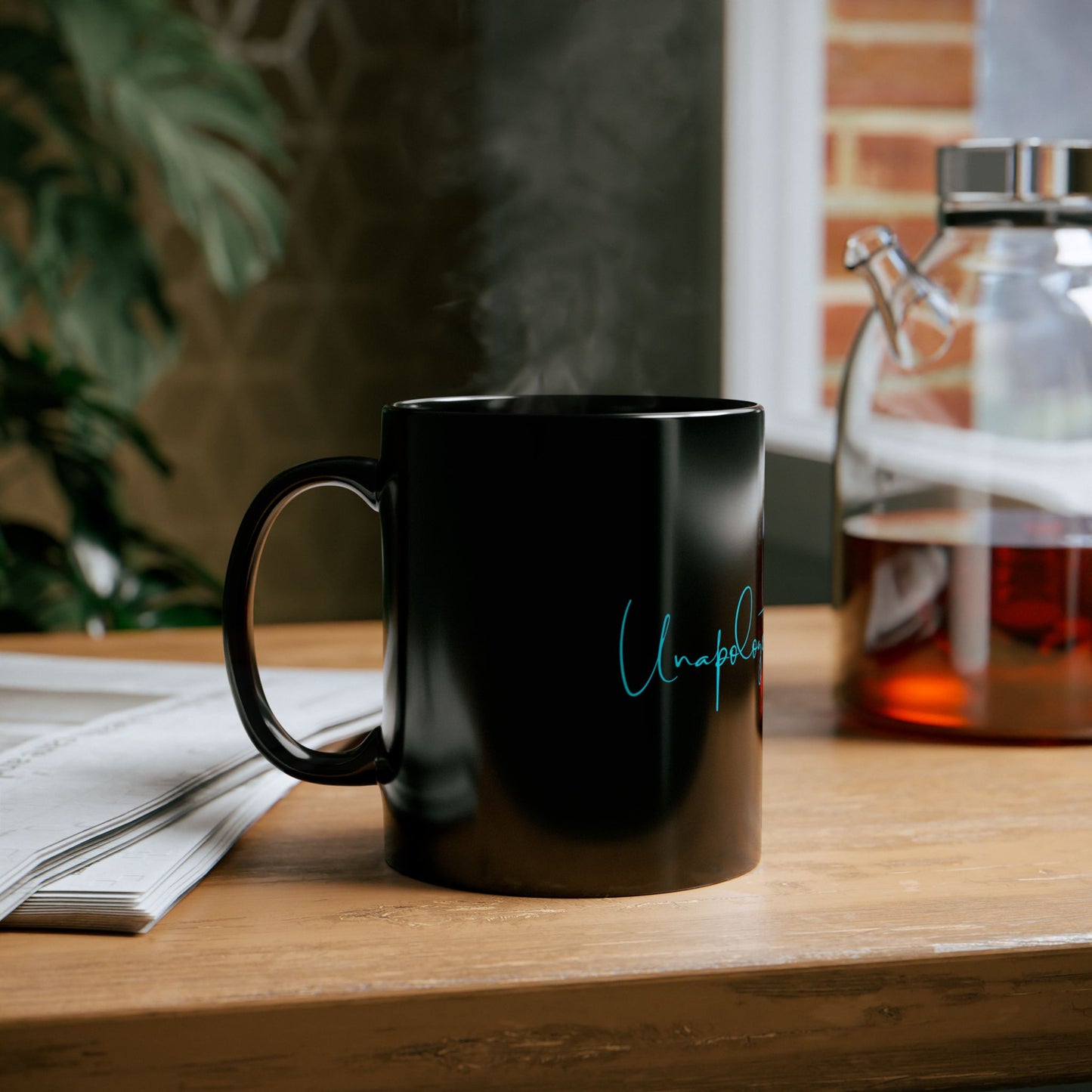 Side view of black ceramic mug with bold teal Unapologetically Me message.