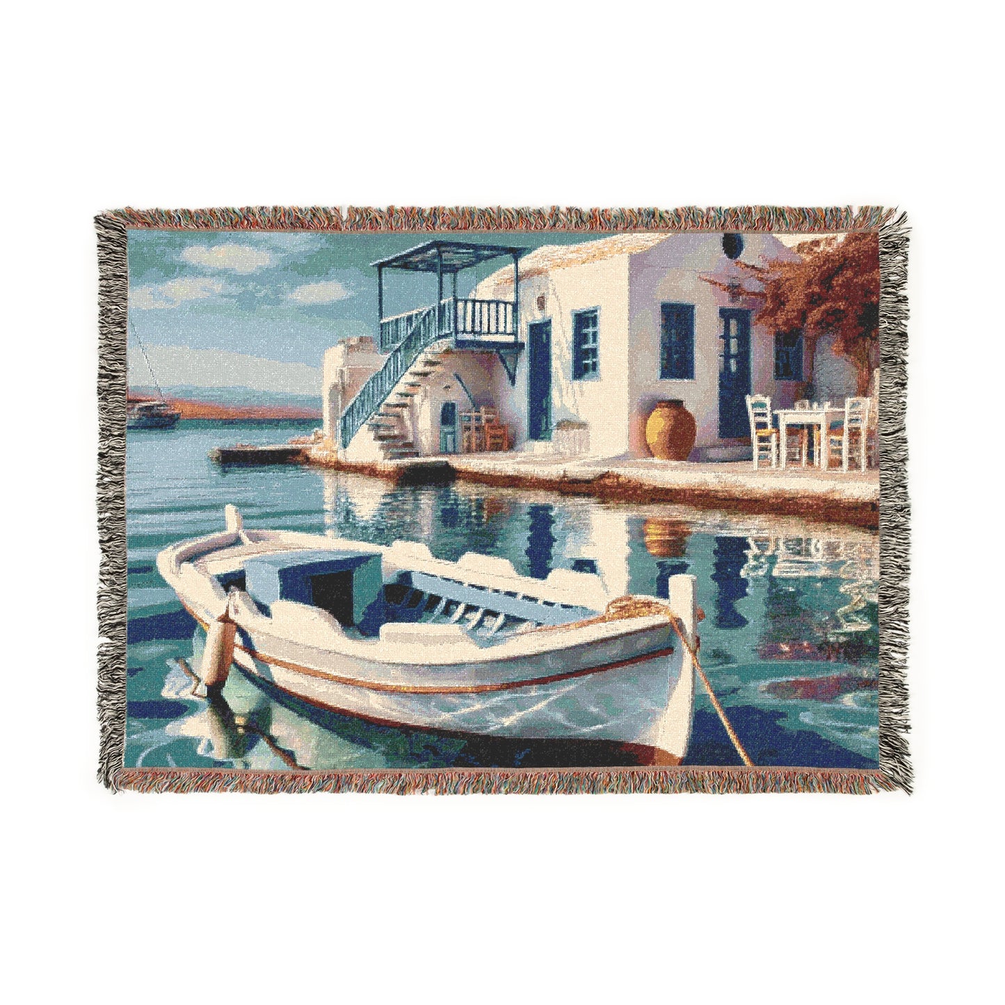 Woven blanket featuring a Mediterranean coastal scene with a boat and waterfront home.