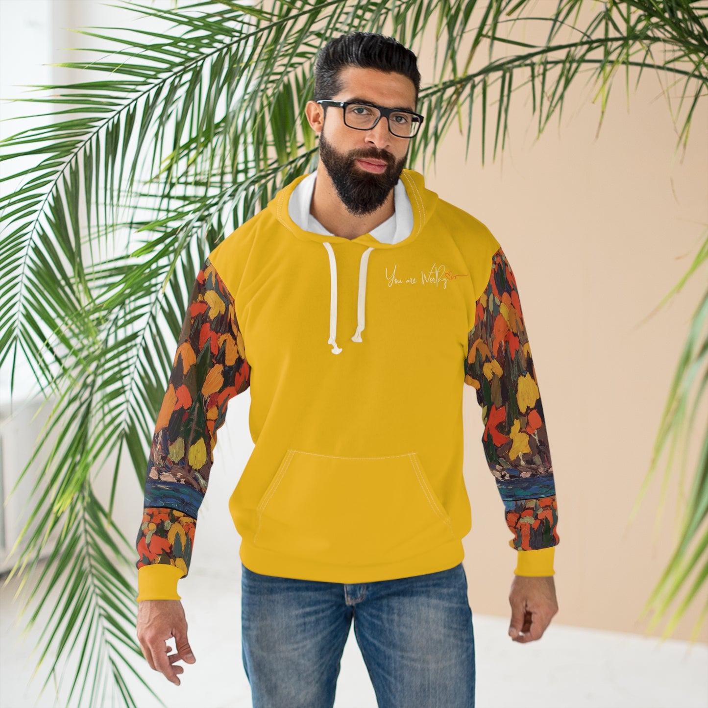 Man modeling the autumn foliage hoodie, displaying the motivational back design with inspiring message and art.