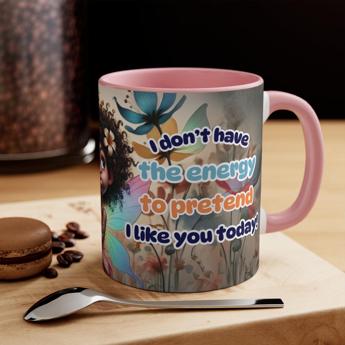 Playful and sassy coffee mug displayed on a wooden counter with coffee beans and a spoon.