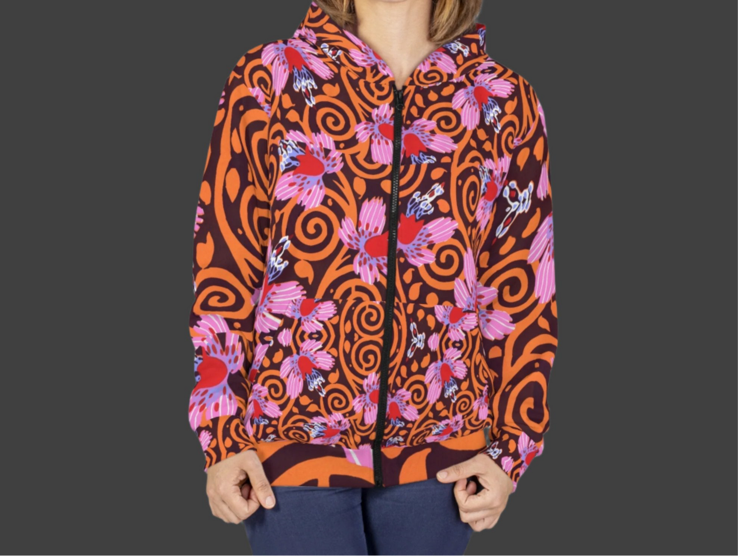Close-up view of the E. A. Séguy-inspired hoodie showcasing vibrant Art Deco floral and swirl patterns in shades of orange, pink, and red. The unisex hoodie features a bold design across the entire front.