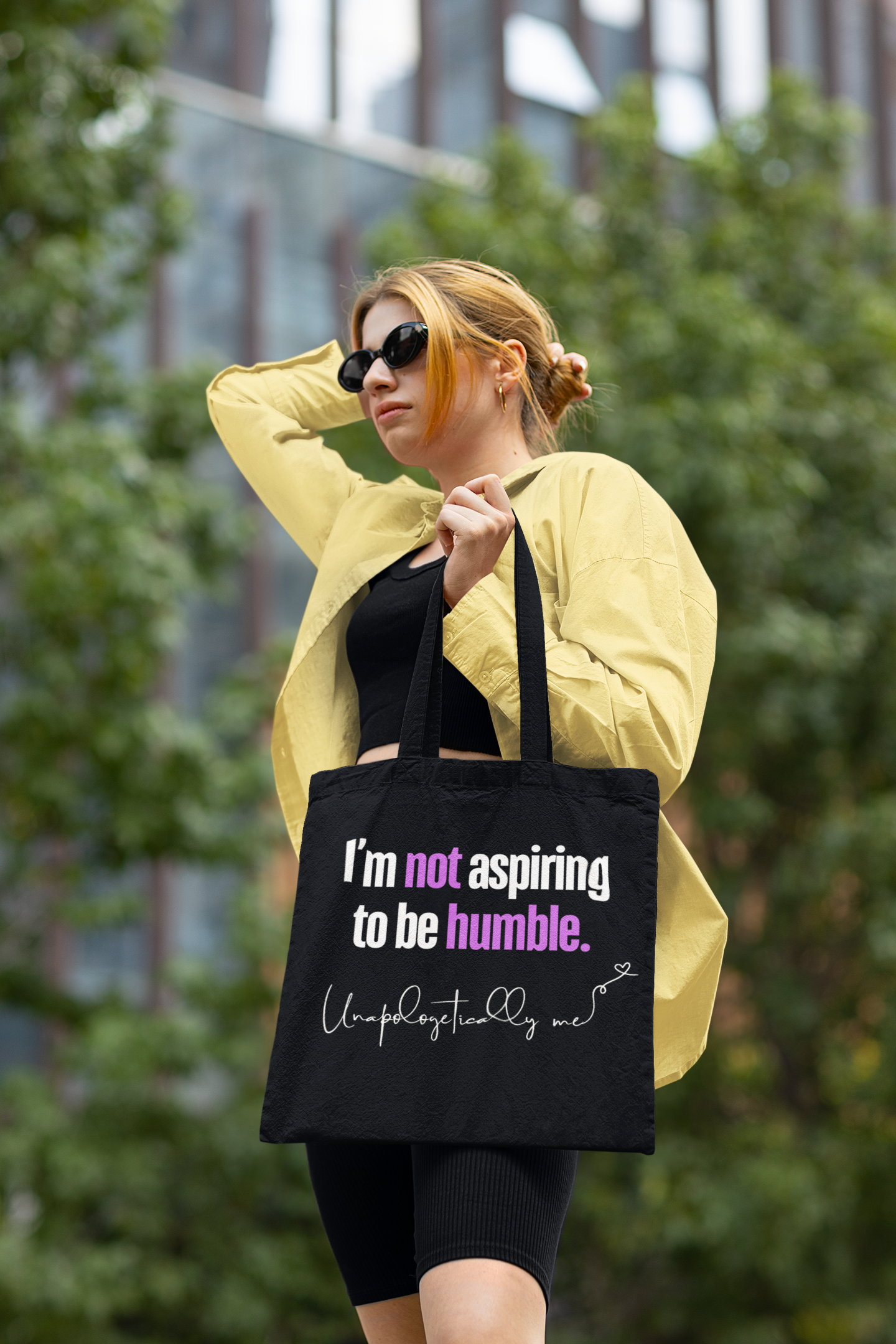 Lifestyle image of the tote bag being carried by a model in a casual setting.