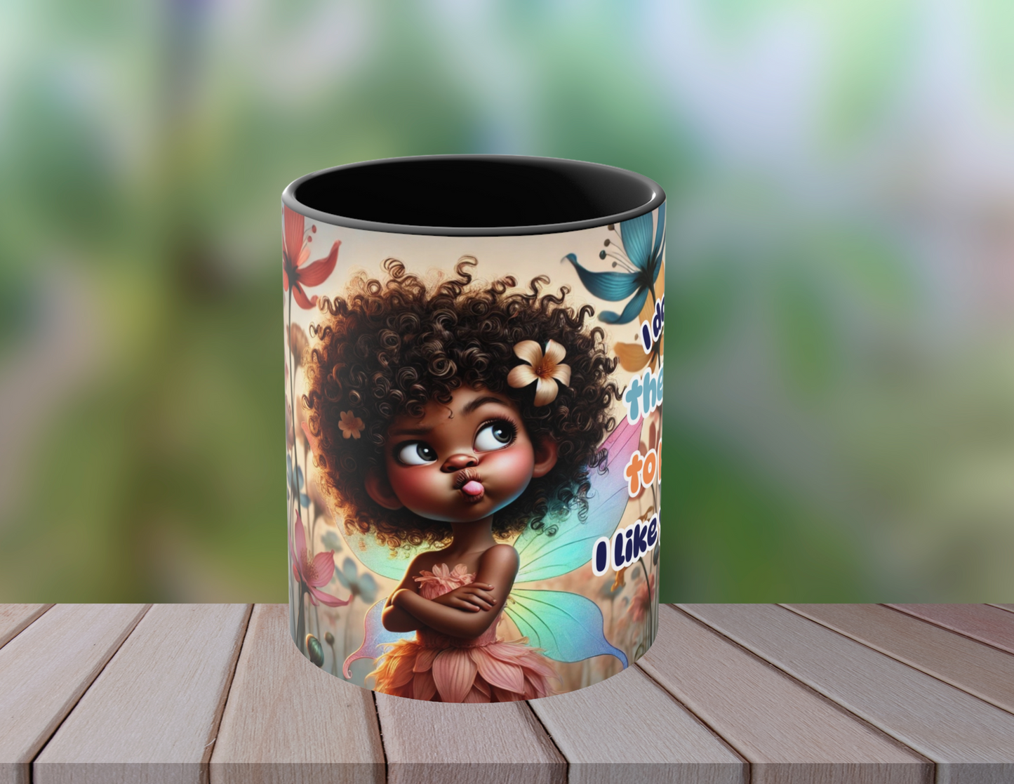A single coffee mug featuring a playful fairy illustration and the text "I don't have the energy to pretend I like you today!" The mug is set on a wooden surface with a soft, blurred garden background, emphasizing the vibrant artwork and warm tones of the mug.