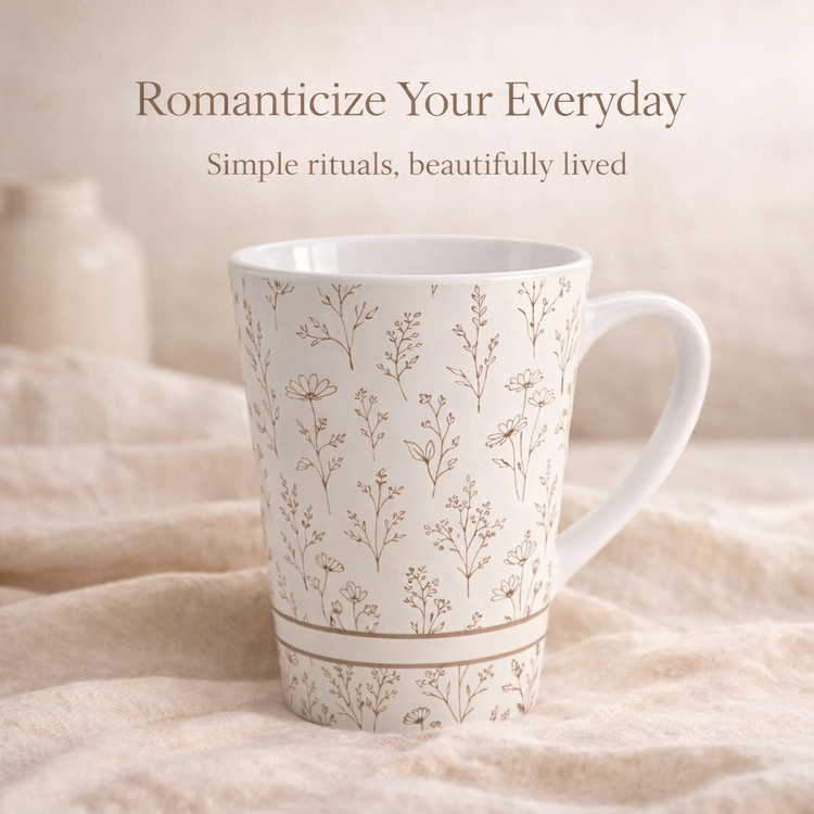 Black Soft Life Society mug with gold Greek-style lettering, steaming gently in a cozy setting with pinecones, fairy lights, and a candle.