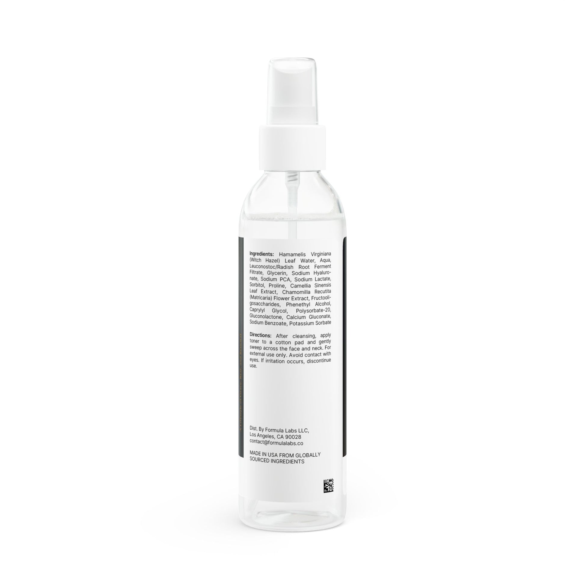 Clear spray bottle with a label on a white background