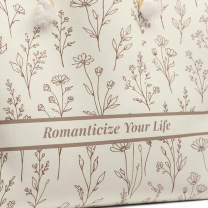 Closeup detail of weekender tote with floral pattern and text 'Romanticize Your Life' on a beige background