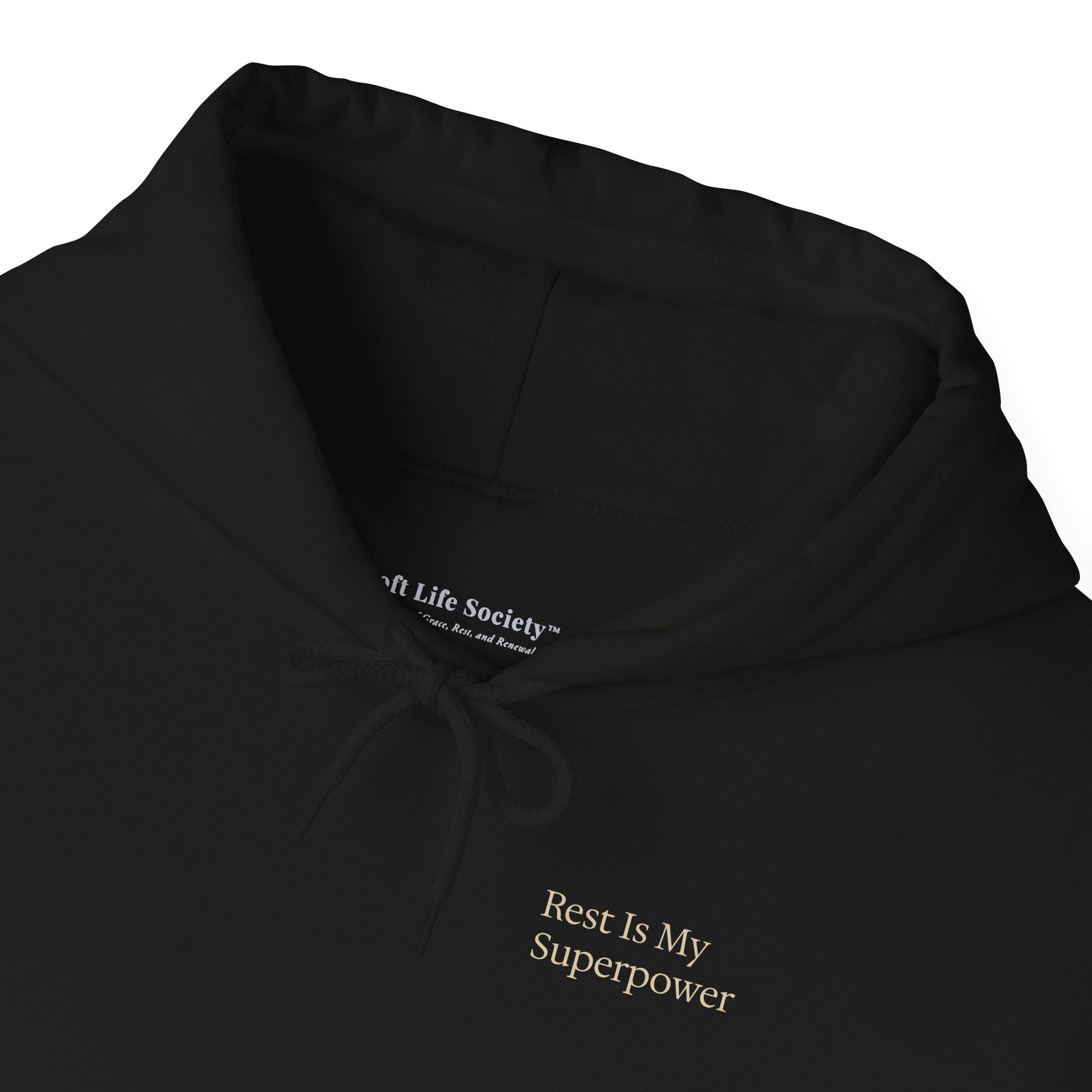 Close-up of the hood and neckline of a black Soft Life Society pullover hoodie showing soft fabric texture.