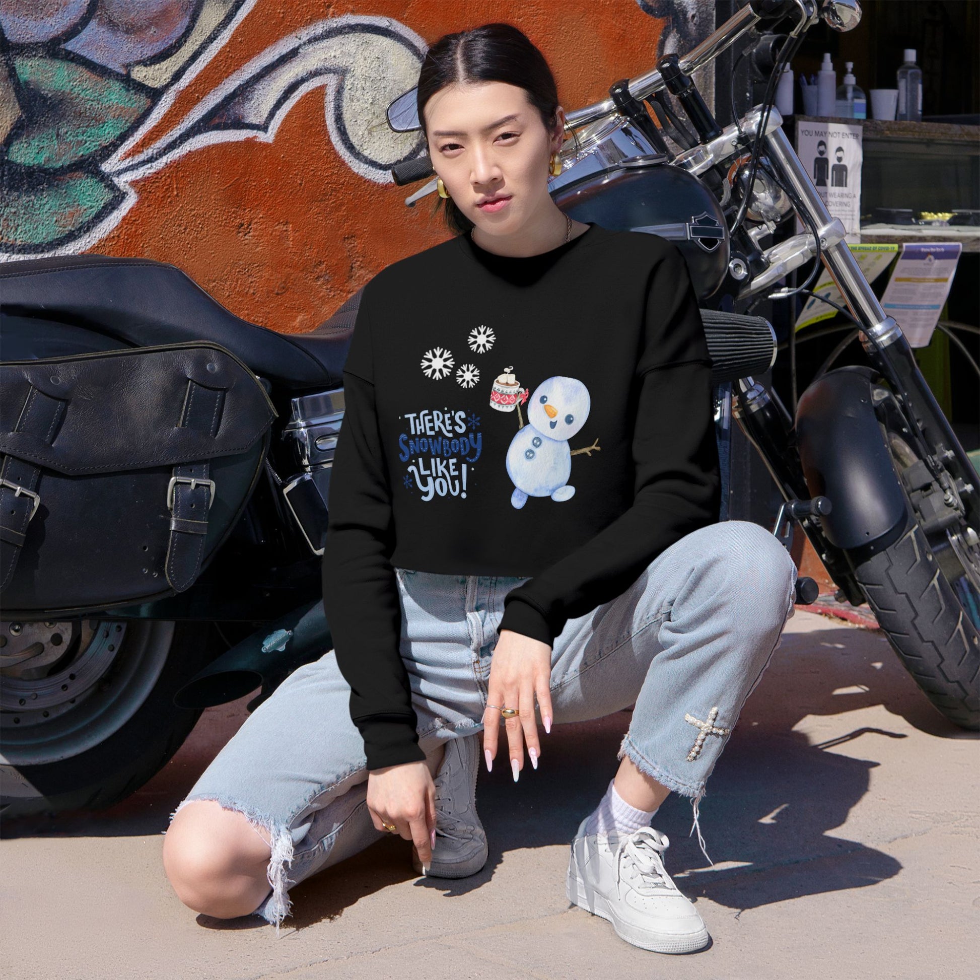 Stylish black cropped sweatshirt with an adorable snowman, snowflakes, and holiday-themed text 'There’s Snowbody Like You' for a cozy, festive look.