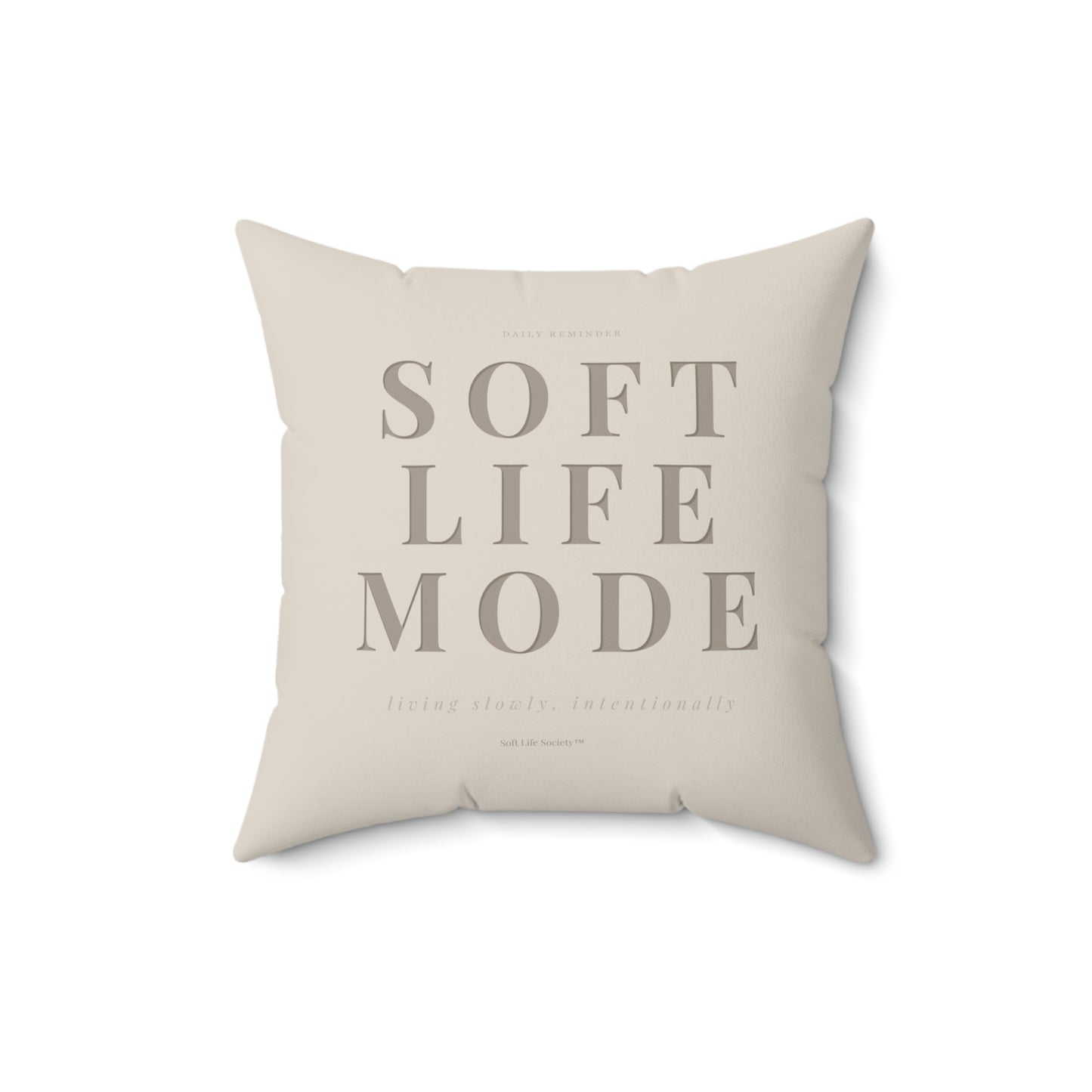 Beige pillow with 'SOFT LIFE MODE' text on a white background